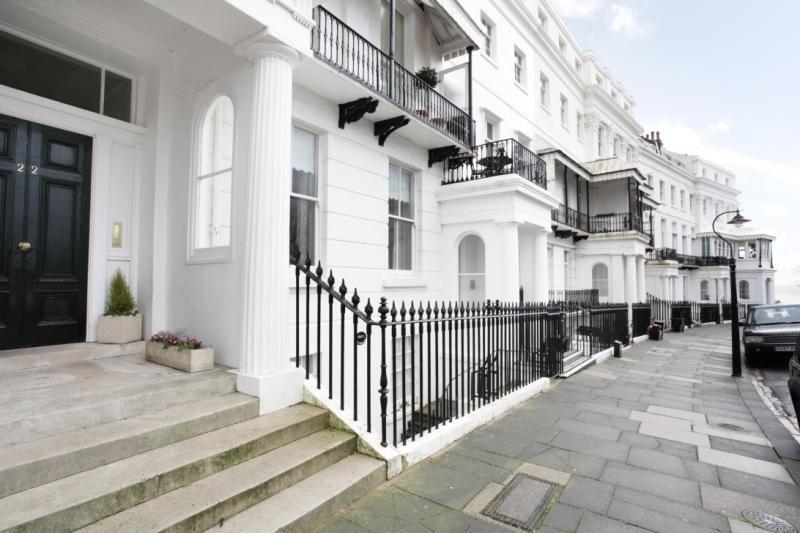 Street-level view of the Regency portico entrance and railings on Lewes Crescent